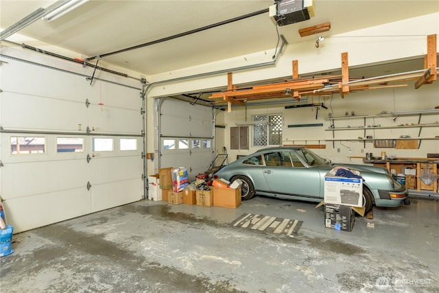 garage with a garage door opener and electric panel