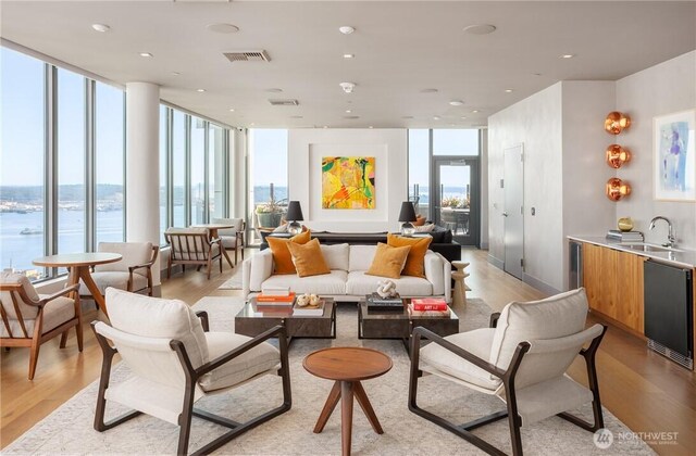 common area with visible vents, a sink, and a water view