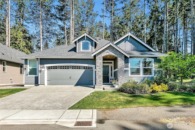 craftsman-style home with an attached garage, a front lawn, stone siding, board and batten siding, and driveway