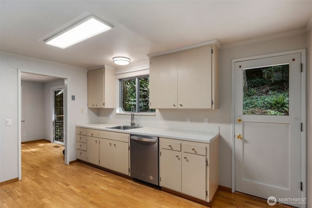 540 SW Fernwood St, Issaquah, WA 98027 - kitchen featuring stainless steel dishwasher, a sink, light countertops, ornamental molding, and light wood-style floors