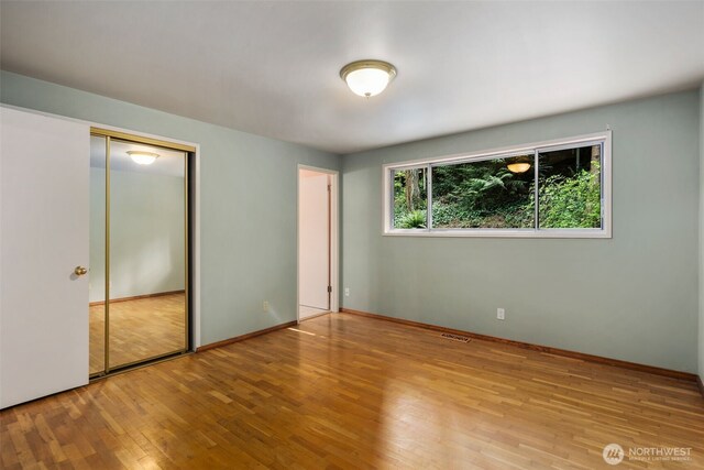 540 SW Fernwood St, Issaquah, WA 98027 - unfurnished bedroom featuring wood finished floors, a closet, and baseboards