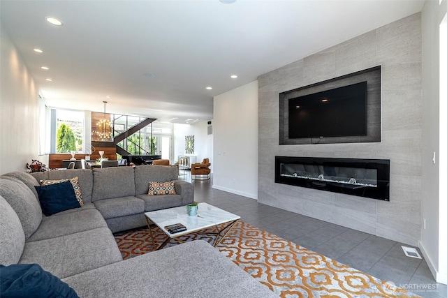 64 Orchard Pl, Orondo, WA 98843 - living room featuring dark tile patterned floors, a notable chandelier, recessed lighting, and a tile fireplace