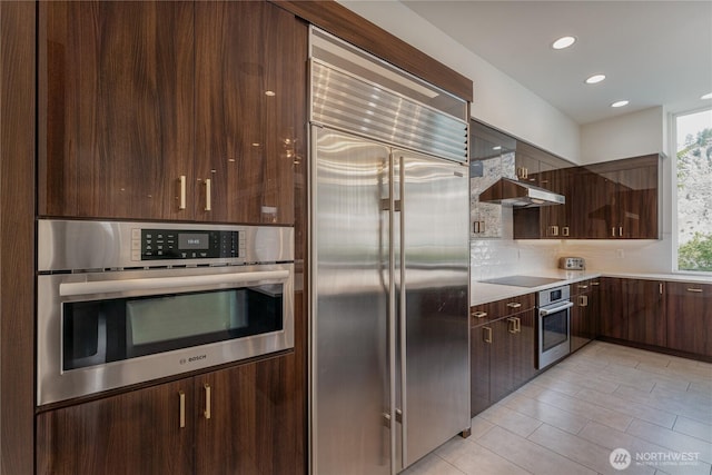 64 Orchard Pl, Orondo, WA 98843 - kitchen featuring dark brown cabinetry, modern cabinets, tasteful backsplash, light countertops, and stainless steel appliances