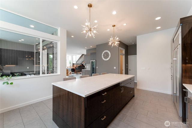 64 Orchard Pl, Orondo, WA 98843 - kitchen with light countertops, a center island, recessed lighting, and light tile patterned flooring