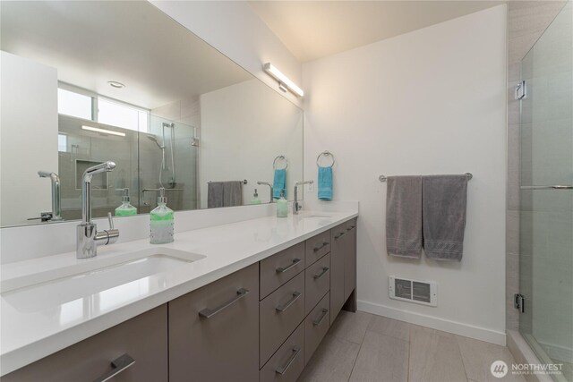 64 Orchard Pl, Orondo, WA 98843 - bathroom featuring double vanity, visible vents, a shower stall, and a sink