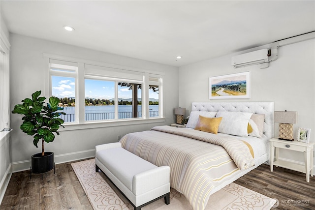 26408 136th Ave SE, Kent, WA 98042 - bedroom featuring a wall mounted air conditioner, a water view, wood finished floors, recessed lighting, and baseboards