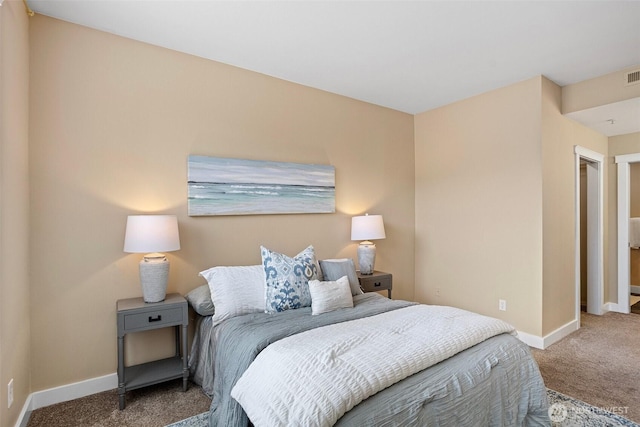 carpeted bedroom featuring baseboards and visible vents