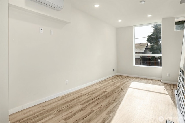1400 N 95th St, Seattle, WA 98103 - unfurnished room with baseboards, light wood-style flooring, recessed lighting, and an AC wall unit
