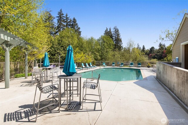 pool featuring a patio and fence