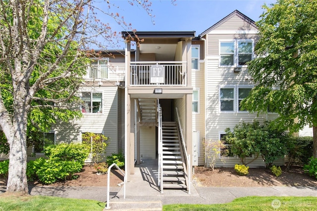 townhome / multi-family property with stairs and a balcony