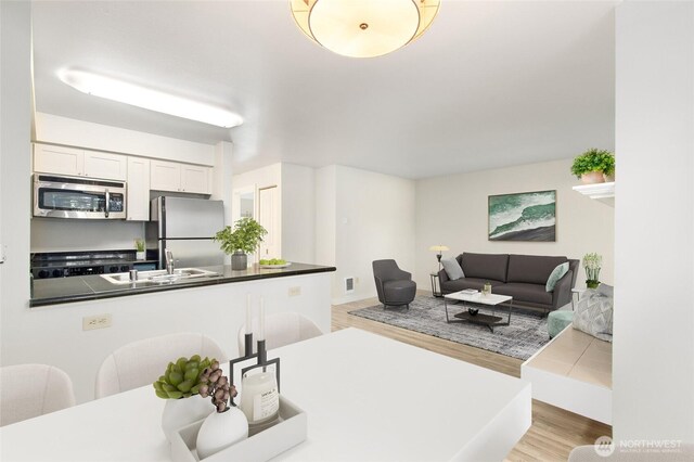 living room with visible vents and light wood finished floors