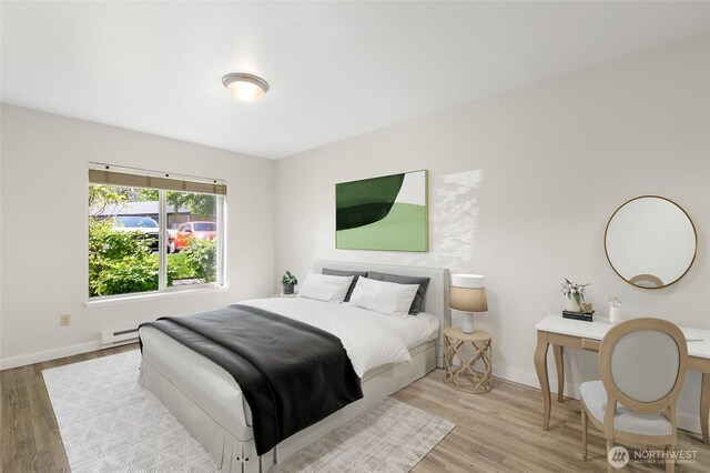 bedroom featuring baseboards and wood finished floors