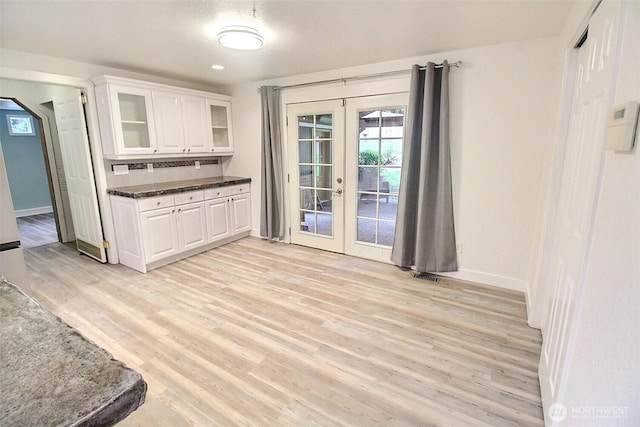 kitchen featuring light wood-style floors, french doors, white cabinetry, and visible vents