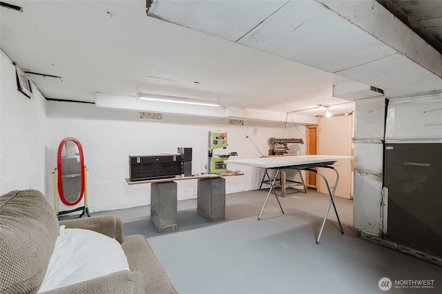 basement with heating unit and a workshop area