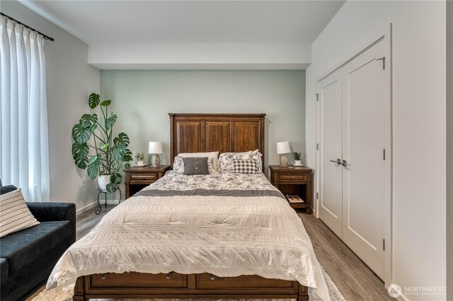 bedroom featuring baseboards and wood finished floors