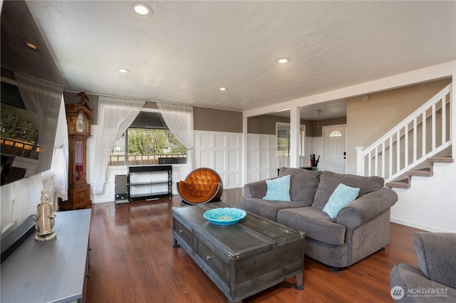 living area featuring recessed lighting, wood finished floors, and stairway