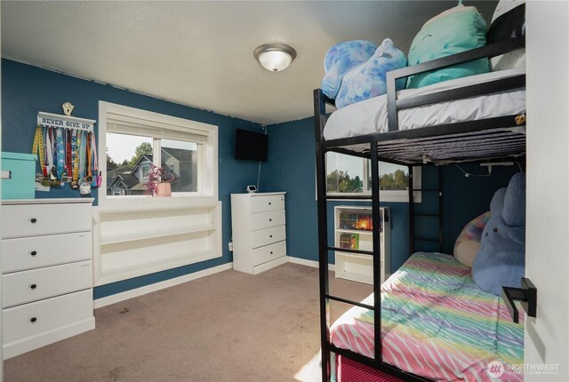 carpeted bedroom featuring baseboards