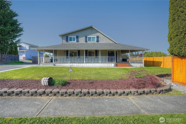 farmhouse inspired home featuring fence, covered porch, a shingled roof, and a front lawn