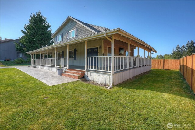 country-style home featuring a front lawn, fence, and covered porch