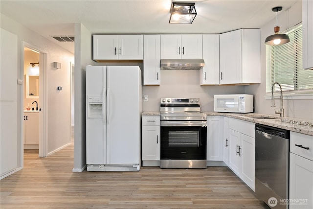 801 141st St S, Tacoma, WA 98444 - kitchen with under cabinet range hood, white cabinetry, appliances with stainless steel finishes, and a sink