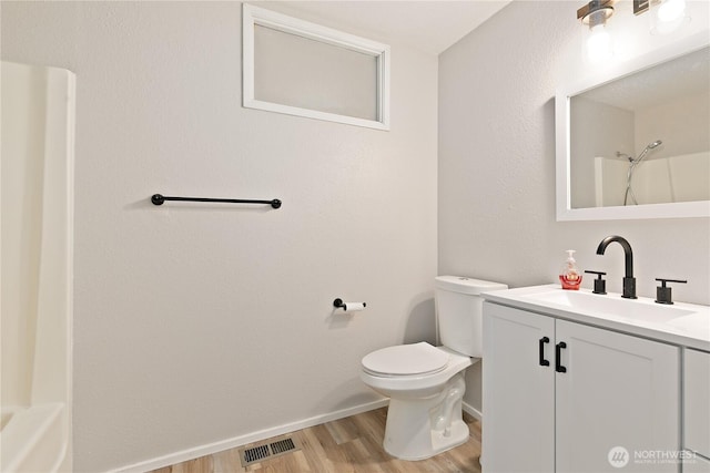 801 141st St S, Tacoma, WA 98444 - full bath with vanity, wood finished floors, toilet, baseboards, and walk in shower