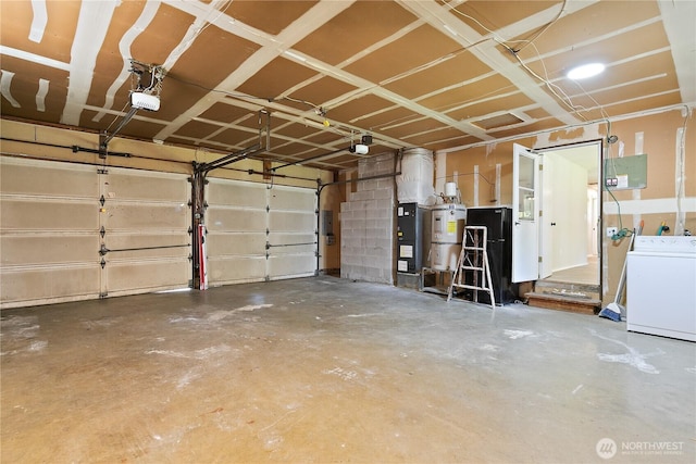 801 141st St S, Tacoma, WA 98444 - garage featuring strapped water heater, washer / dryer, and a garage door opener