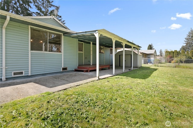 801 141st St S, Tacoma, WA 98444 - back of house with a storage shed, a lawn, an outbuilding, fence, and a patio