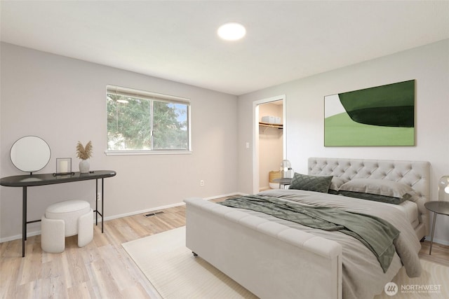 801 141st St S, Tacoma, WA 98444 - bedroom with a spacious closet, baseboards, wood finished floors, and visible vents