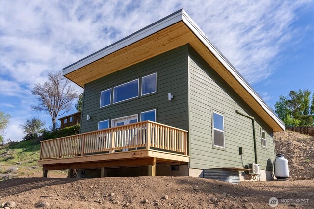 rear view of property featuring a deck