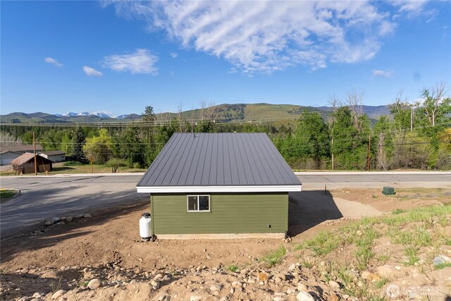 view of outbuilding with a mountain view