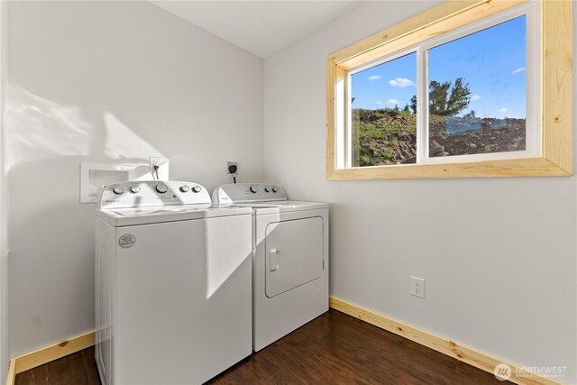 laundry room featuring baseboards, laundry area, dark wood-style floors, and washing machine and clothes dryer
