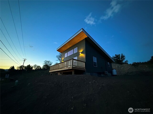 back of house featuring a wooden deck and cooling unit
