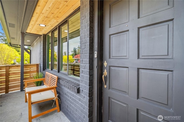doorway to property featuring visible vents and covered porch