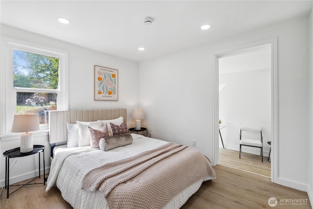 bedroom with recessed lighting, baseboards, and wood finished floors