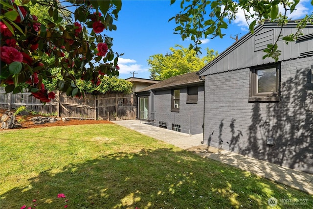 view of yard with fence and a patio area