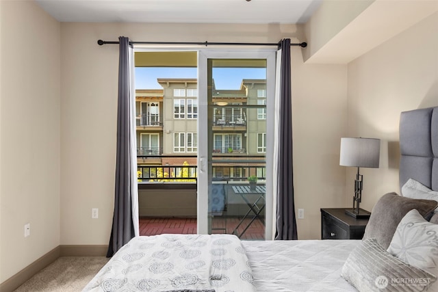 carpeted bedroom featuring access to outside, baseboards, and multiple windows