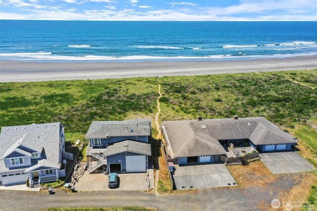 drone / aerial view featuring a beach view and a water view