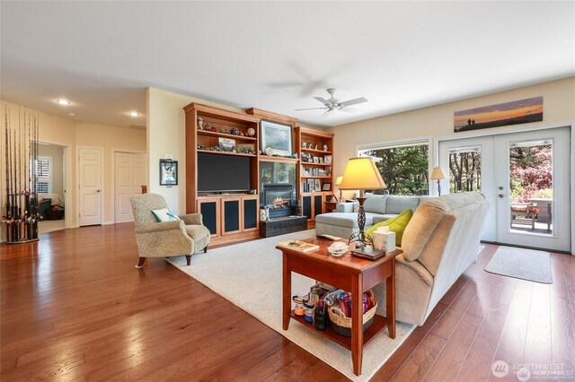 living room with recessed lighting, a ceiling fan, dark wood-style floors, and french doors