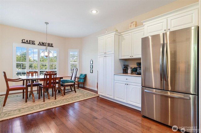 kitchen featuring dark wood finished floors, baseboards, freestanding refrigerator, and recessed lighting
