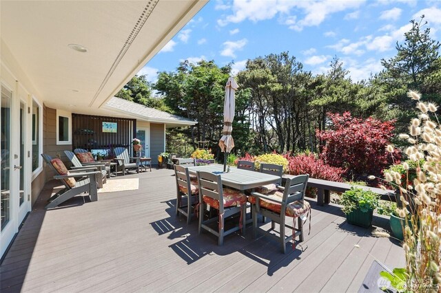 wooden deck featuring outdoor dining area