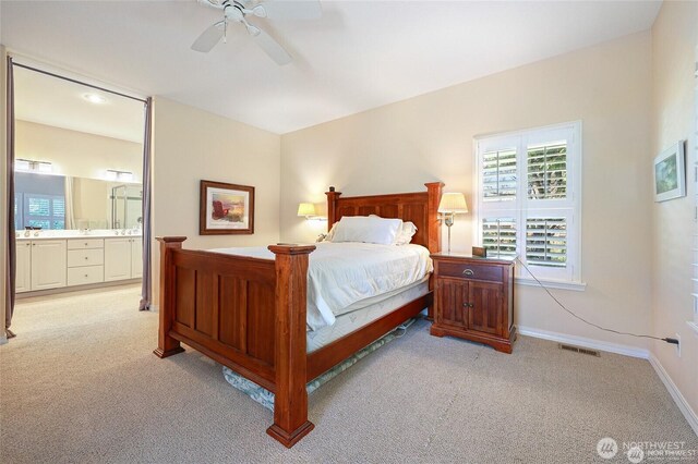 bedroom with visible vents, baseboards, multiple windows, and light carpet