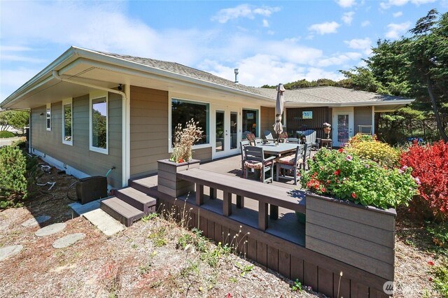 rear view of house featuring outdoor dining area