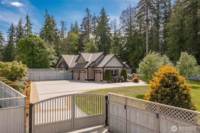 view of front of property with a gate and concrete driveway