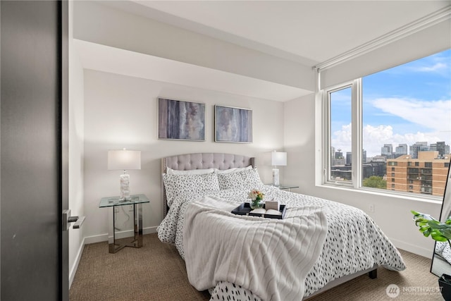 carpeted bedroom featuring baseboards