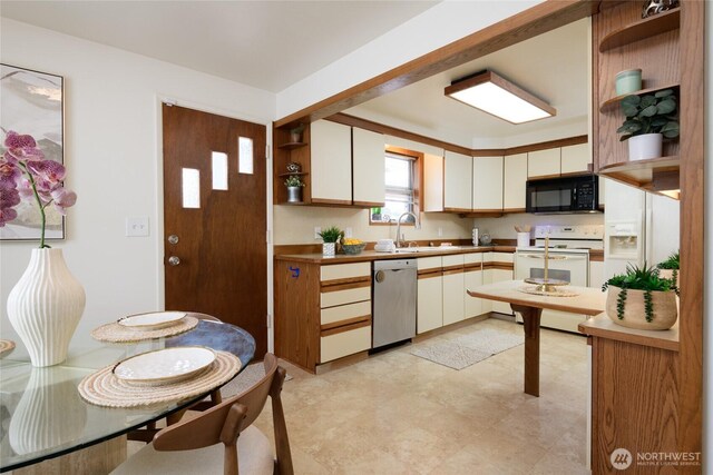 12223 4th Ave NW, Seattle, WA 98177 - kitchen with electric range, black microwave, stainless steel dishwasher, open shelves, and a sink
