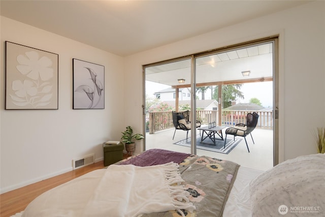 12223 4th Ave NW, Seattle, WA 98177 - bedroom featuring visible vents, baseboards, wood finished floors, and access to exterior