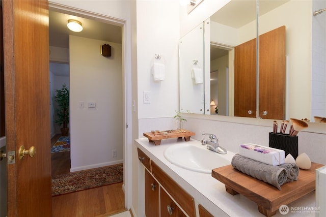 12223 4th Ave NW, Seattle, WA 98177 - bathroom featuring vanity, baseboards, and wood finished floors
