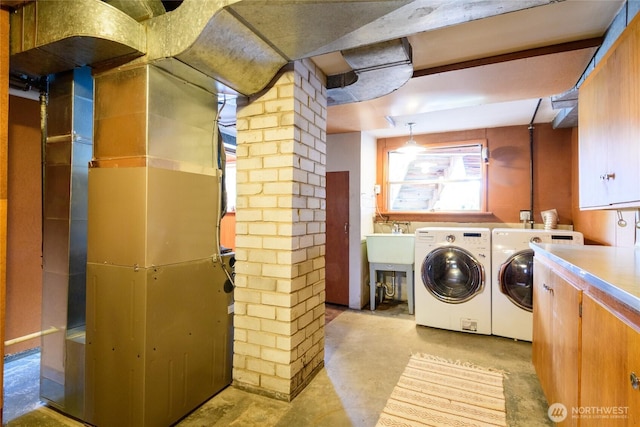 12223 4th Ave NW, Seattle, WA 98177 - laundry room with cabinet space, washer and dryer, and decorative columns