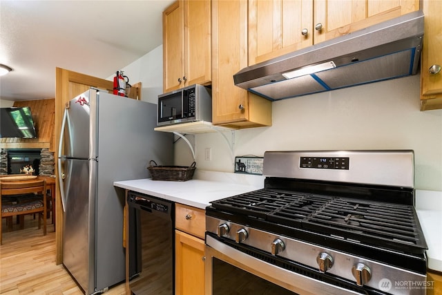 7502 Glacier Spgs, Deming, WA 98244 - kitchen with appliances with stainless steel finishes, under cabinet range hood, light countertops, and light wood finished floors