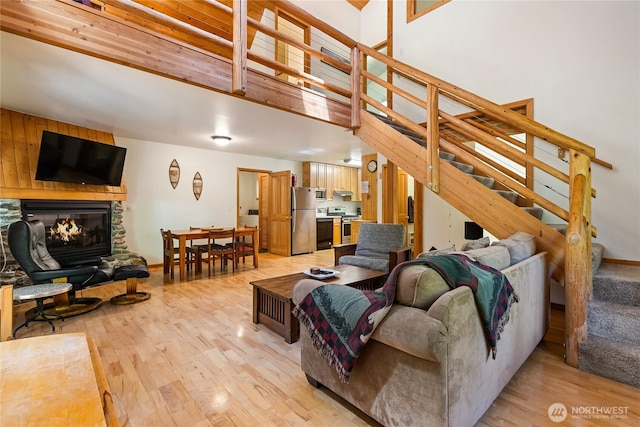 7502 Glacier Spgs, Deming, WA 98244 - living room with stairs, light wood-style floors, and a glass covered fireplace